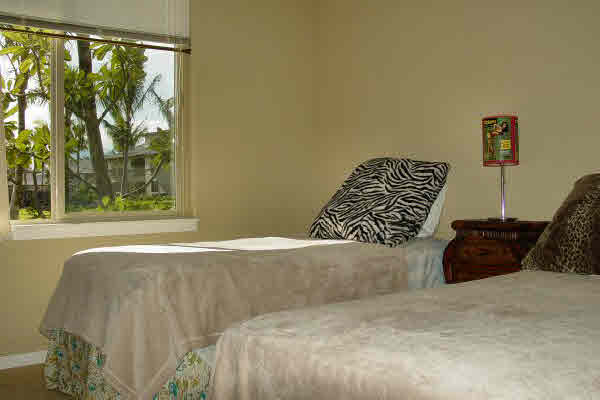 Guest Bedroom has Lovely Garden Outlook through Large Picture Windows.