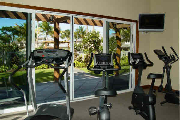Fitness Center with Quality Equipment and Televisions, overlooks Pool Area.