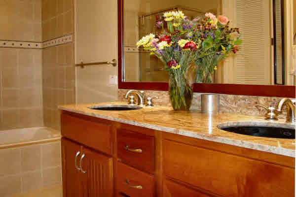 Custom Wood Cabinets, Large Soaking Tub, Tiled Floors.